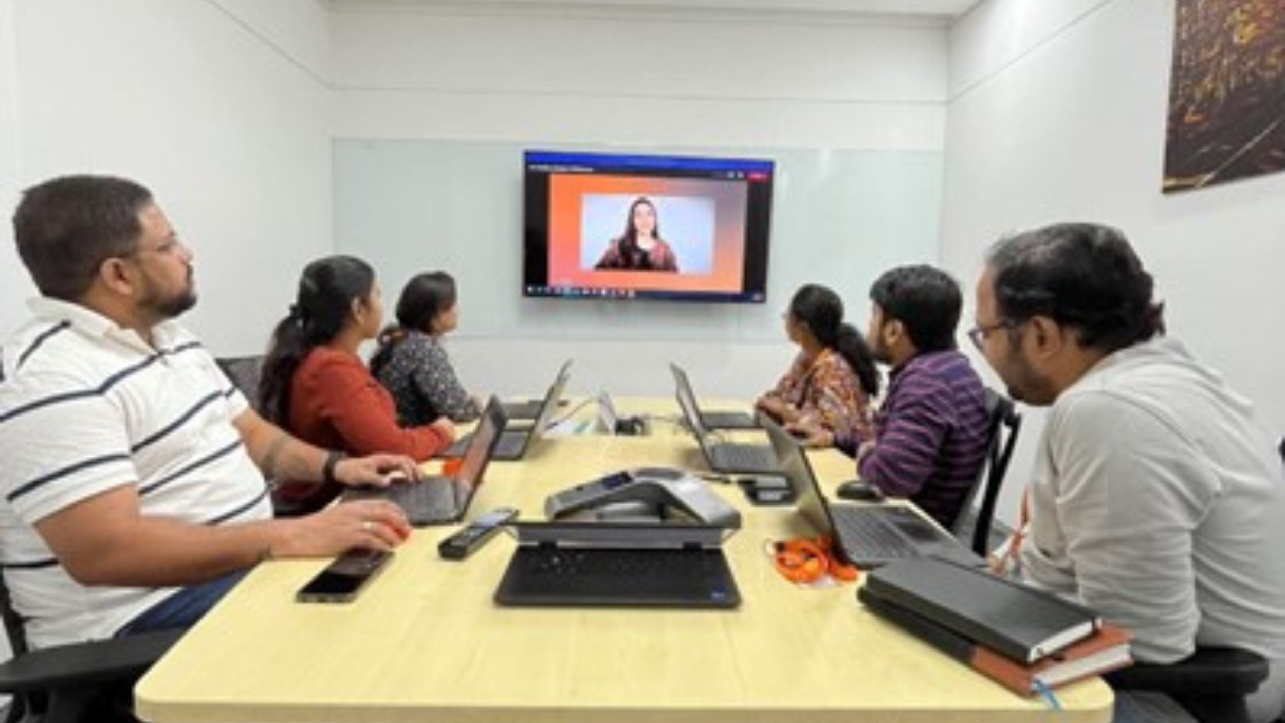 Saurabh and teammates sitting at a conference table during Global Learning Day